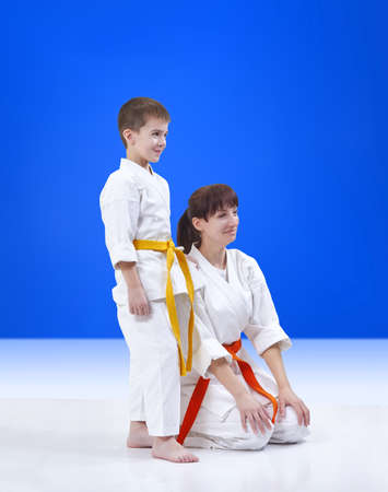 On a blue background mother and son the athletes with a smile on his faceの写真素材