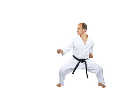 In a low karate stand, an athlete trains a punchの写真素材