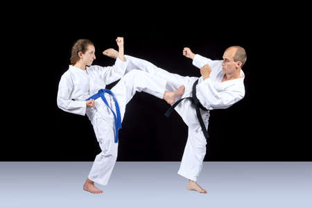 A woman and a man are beating kick to meet each otherの写真素材