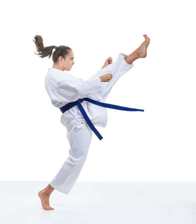 Sportswoman is training a kick in karategiの写真素材