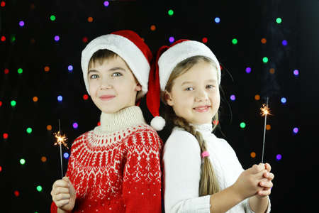 Two children with Bengal lights in their hands