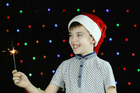 In the cap of Santa Claus, a little boyの写真素材