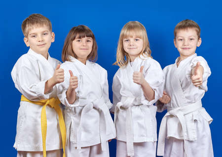 Cheerful sportsmen in karategi are showing finger superの写真素材