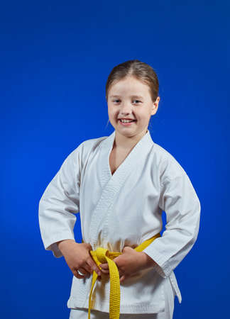 Cheerful sportswoman on a blue backgroundの写真素材