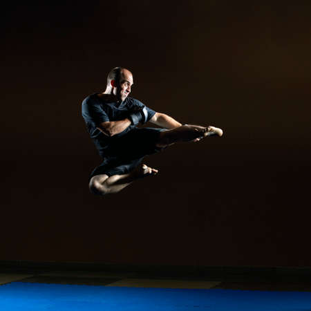 Kick the foot in the leap the adult athlete beats in sideの写真素材