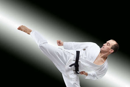 The athlete beats a kick on the gradient backgroundの写真素材