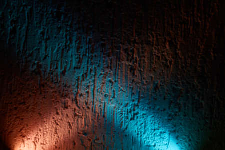 Blue and pink glow overlaps the textural backgroundの写真素材