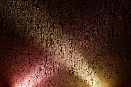 On the textural background, the intersection of the rays of pink and yellowの写真素材