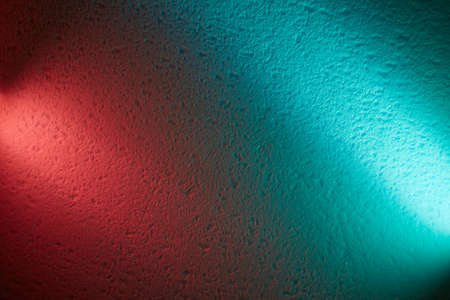 Turquoise and pink light of lanterns divide the background into two parts