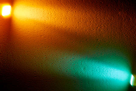 Yellow and turquoise lantern lights illuminate the background to meet each otherの写真素材