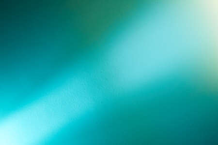 On a turquoise background, a light turquoise intermittent beam of lightの写真素材