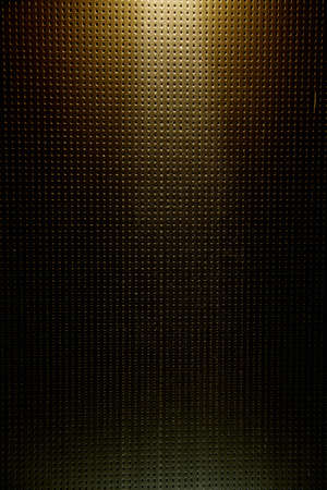 Light yellow vertical ray of light against a dark background to a pointの写真素材