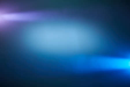 Around a white blurred cloud of light, light blue and light purple rays of lightの写真素材