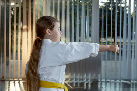 Beautiful sportswoman trains a punch with her handの写真素材