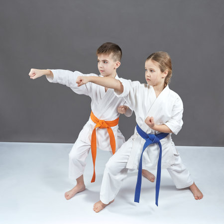 Girl and boy in karategi hit with a handの写真素材