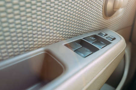 Car door inside. Interior trim, bright interior. Electric glass buttonsの写真素材