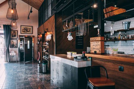 ZATOKA, UKRAINE - JUNE 14 2021: The interior of the restaurant's pub is in a modern retro style with a predominance of wood and metal finishes. Right grill rackのeditorial素材