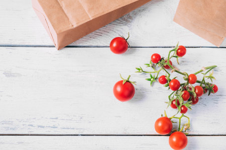 Cherry tomatoes on a white wooden table. View from above.の写真素材