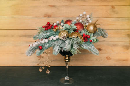 Christmas candlestick on a background of a wooden wall. Table decoration for the new year.の写真素材