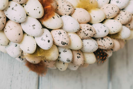 Easter wreath of eggs on a light wooden background. Easter decoration for the home. Festive decoration.の写真素材