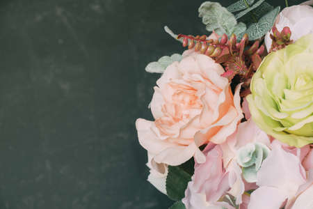 Bouquet of artificial flowers on gray-green background. copyspace.の写真素材