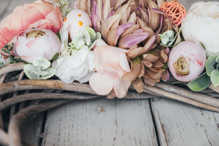 Part of Easter decoration in brown tones on light wooden table.の写真素材