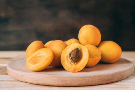 Apricots on a wooden kitchen board.の写真素材