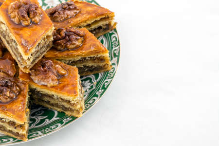 Honey baklava on the saucer with oriental designの写真素材