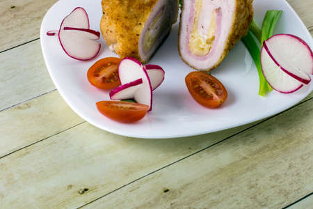 Chicken cordon bleu with vegetablesの写真素材