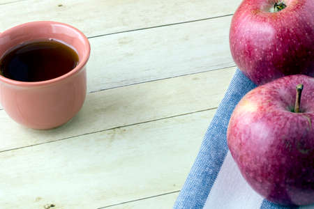 Red Apple and cloth napkin on light wood backgroundの写真素材