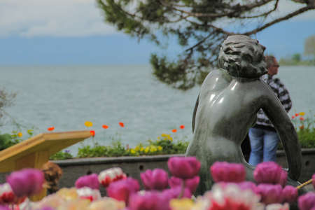 Monument of women looking at the lake and the mountainsの写真素材