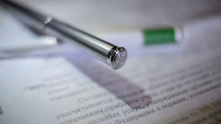 Expensive and beautiful shiny metallic pen on documentsの写真素材