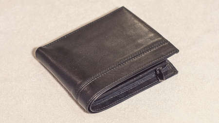 Leather black wallet on a light background