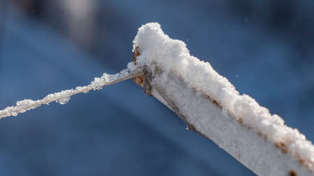 Clothesline covered with ice and snowの写真素材