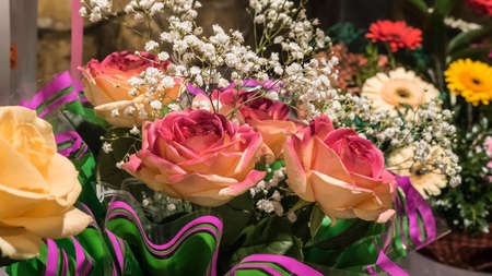 Beautiful bouquet of fresh beige and multicolored rosesの写真素材