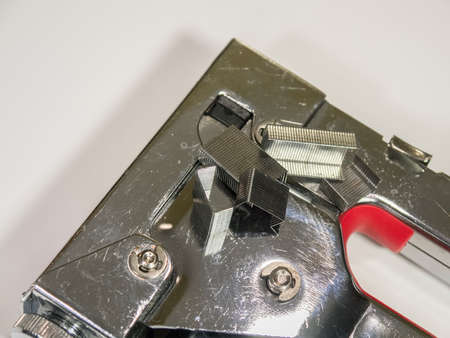 Staple gun and staples on white isolated background closeupの写真素材