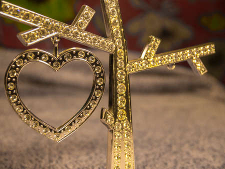 Gold diamond heart on the blurred backgroundの写真素材