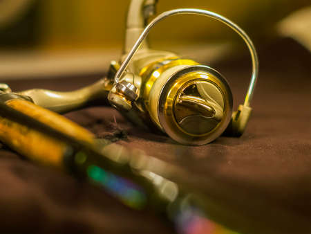 Golden fishing reels on the rodの写真素材
