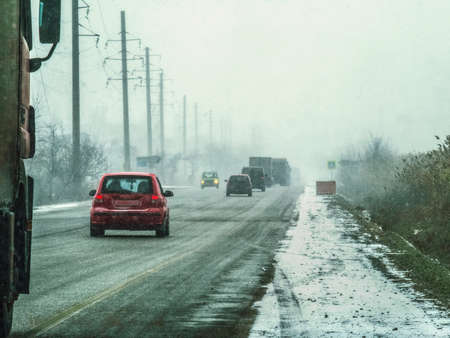 Cars driving in a snow stormの写真素材
