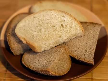 Pieces of white and black bread on a plateの写真素材