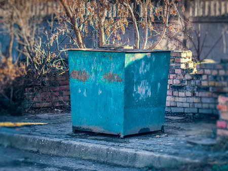 The large iron trash bin in the yardの写真素材