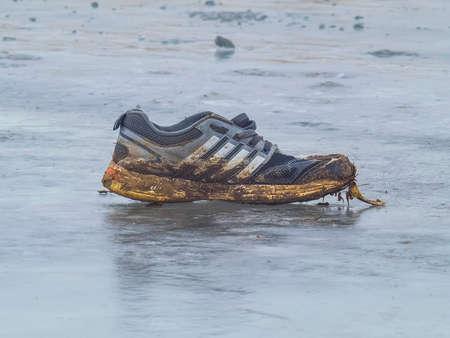 The dirty Sneakers froze on the ice