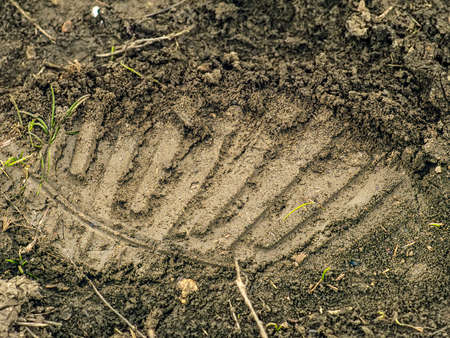 A clear boot print in the mudの写真素材