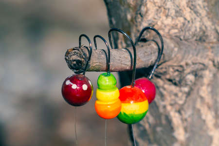 the colored floats with hooks for fishing closeupの写真素材