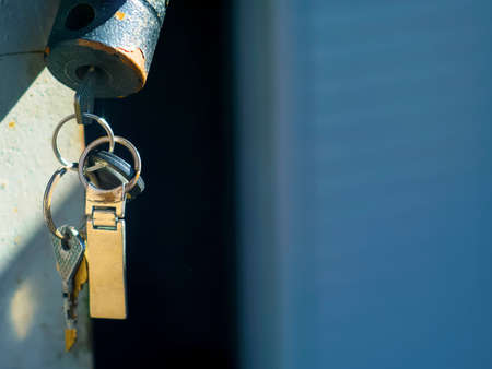 Old locks with keys on a garage doorの写真素材