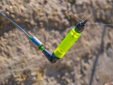 Bright lime lettuce indicator on the fishing rod close-up
