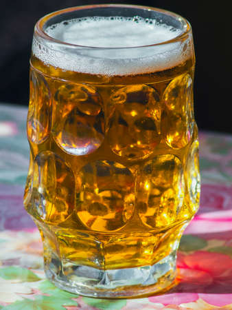 glass of fresh beer on a tableの写真素材