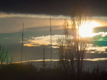 A unique sunset over the city between the cloudsの写真素材