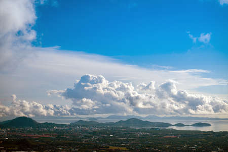 The landscape of the mountain ridge of Phuket and the Adaman Sea against the background of a blue sky with clouds.の写真素材