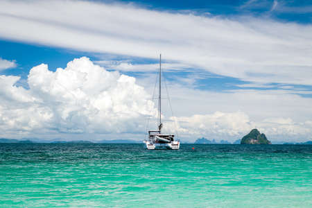 Beautiful seascape with azure water of the Adaman Sea with a yacht and blue sky with clouds. Thailandの写真素材